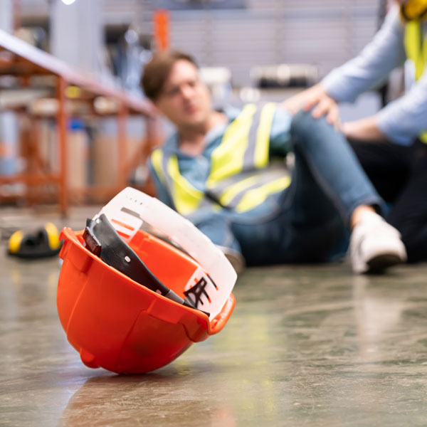 hard hat and worker on ground after slip and fall